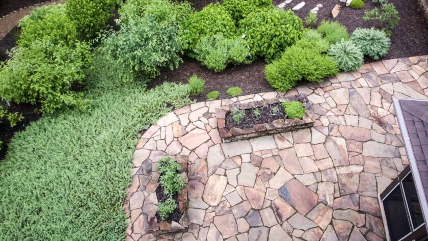 An aerial view of a garden and patio built by a hardscape contractor using Tennessee flagstone.