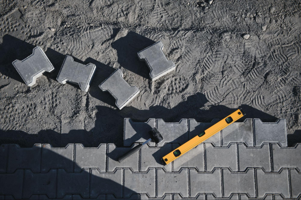 Paving stones arranged neatly with a level in a landscape paver design layout